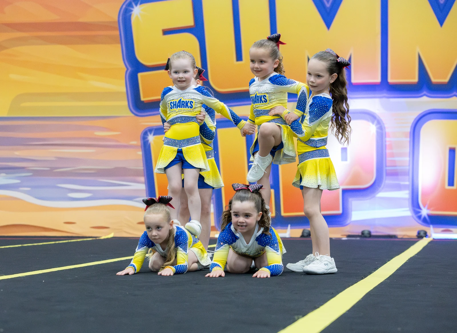 A young cheer team performing at Summer Flipout
